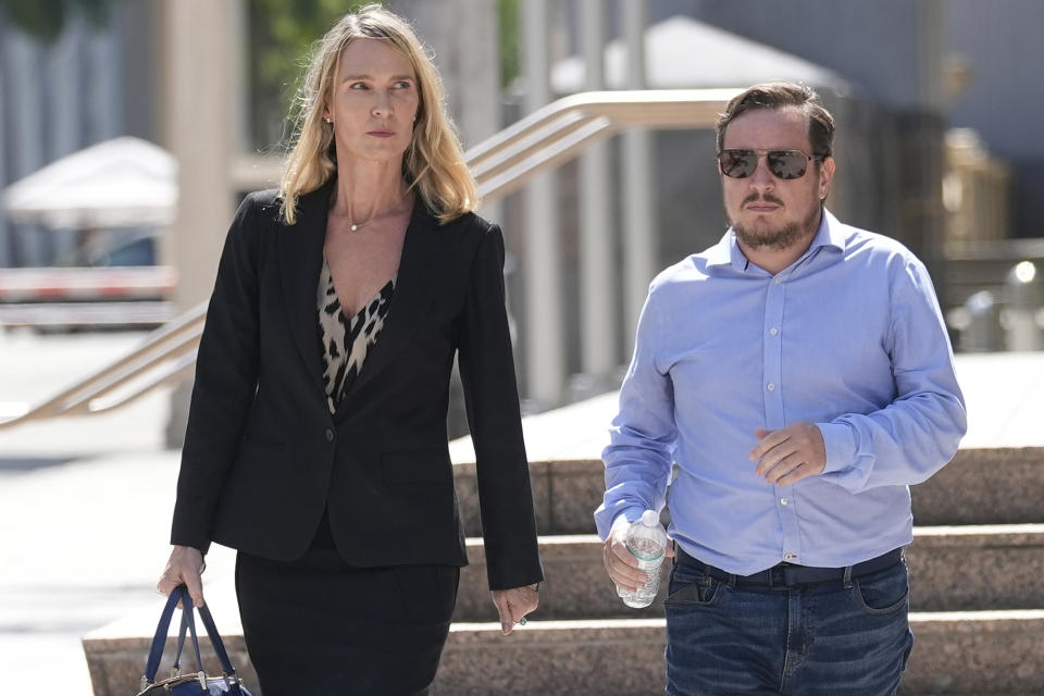 Juan Henao walks with attorney Courtney Caprio following a federal court hearing into the disappearance of his sister Ana Maria Henao Knezevich, Friday, May 10, 2024, in Miami. David Knezevich was denied bond after he was arrested and charged with kidnapping in the disappearance of his wife, Ana Maria Henao Knezevich from her apartment in Spain. (AP Photo/Marta Lavandier)