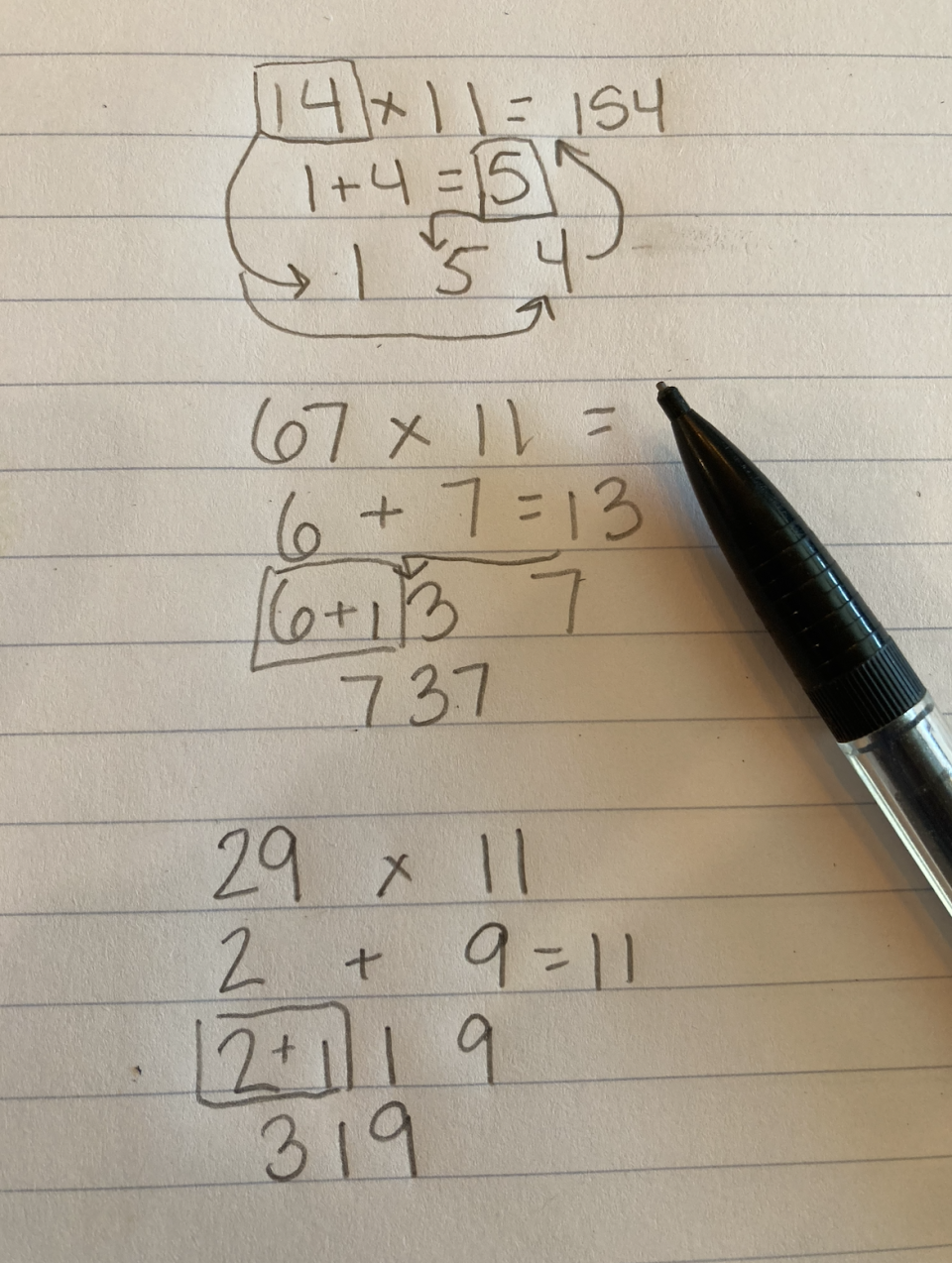 Handwritten math equations with mistakes and a pen to the right side