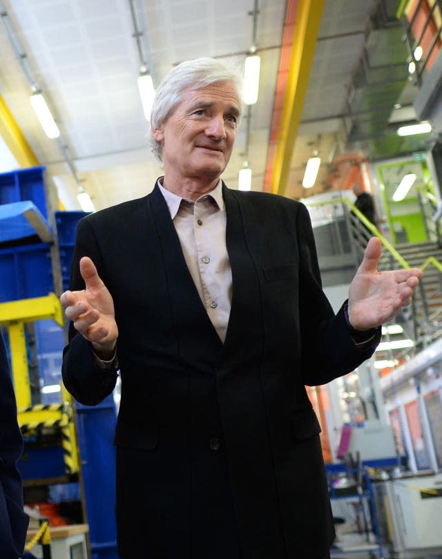 James Dyson stands on a bus