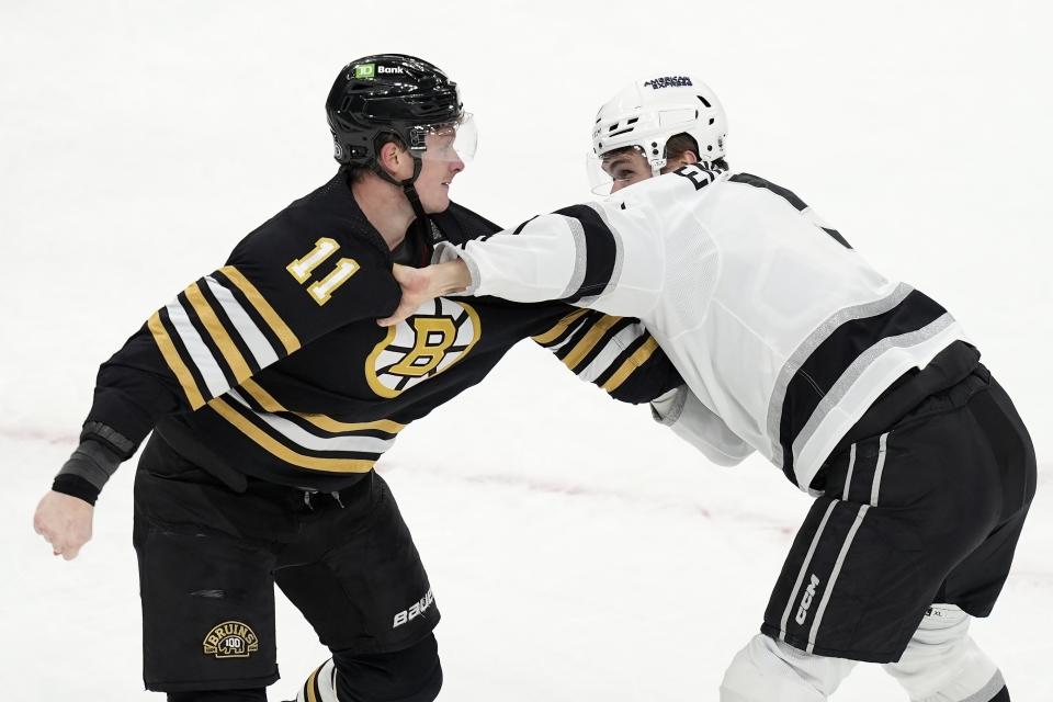 Boston Bruins' Trent Frederic (11) and Los Angeles Kings' Andreas Englund fight during the first period of an NHL hockey game, Saturday, Feb. 17, 2024, in Boston. (AP Photo/Michael Dwyer)