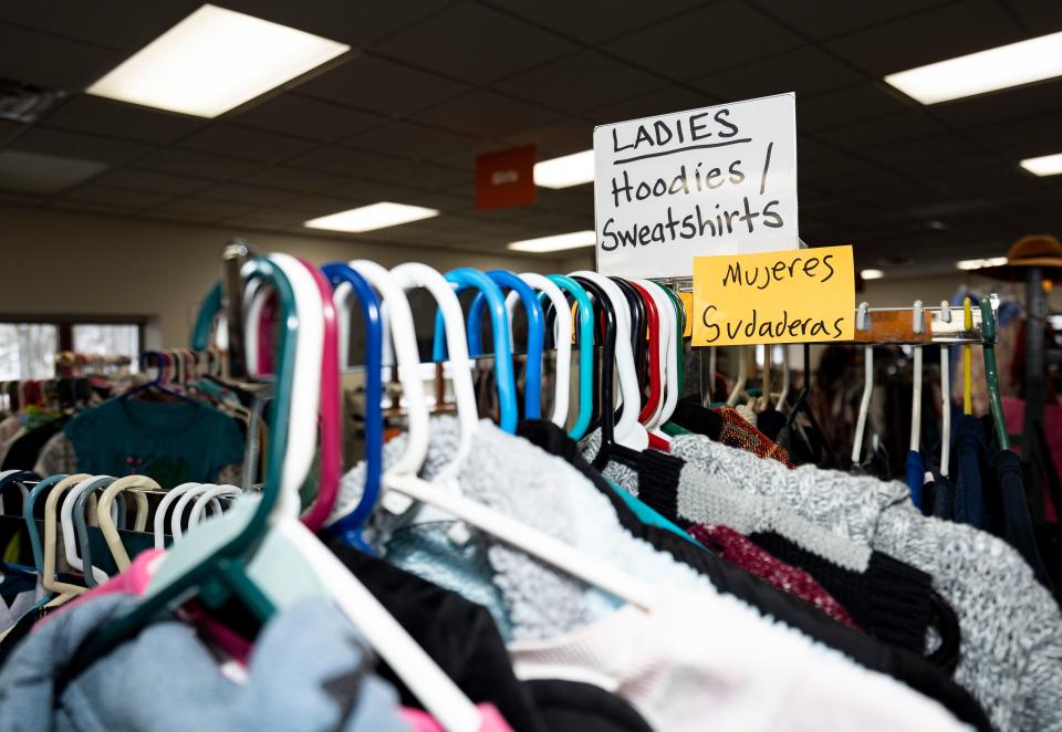 A clothing rack with signage in English and Spanish is seen at the Community Space on Wednesday, January 10, 2024 in Whitewater, Wis.
