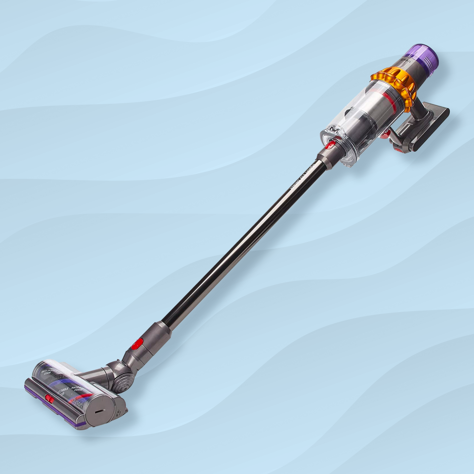 the dyson v15 detect stick vacuum in front of a blue wavy background