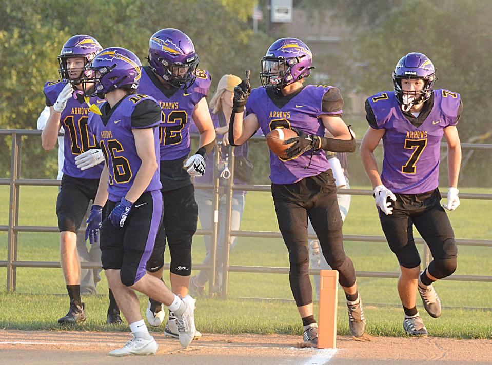 Watertown's Nathan Briggs (with football) receives congratulations from teammates Kohen Kranz (10), Shey Coltrin (16), Nash Berg (62) and Mitch Olson (7) after catching a 19-yard touchdown pass in the Arrows' 33-0 season-opening win over Brookings on Friday, Aug. 25, 2023 at Watertown Stadium.