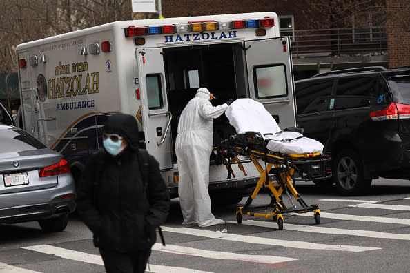 An ambulance driver puts away and cleans a medical gurney outside of  Mount Sinai Hospital which has seen an upsurge of coronavirus patients in New York City. 