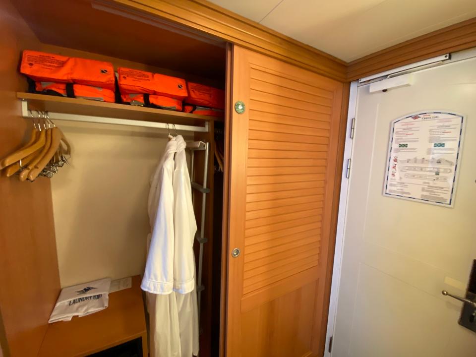 robes and life jackets in a closet inside a stateroom on the disney magic cruise line