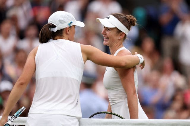 Elina Svitolina (right) hugs Iga Swiatek at the end of their match 