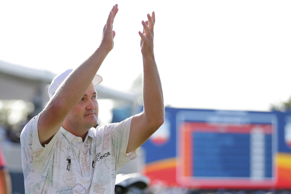 Jason Kokrak claps back to the gallery in the stands after his last putt to win on the final round of the Houston Open golf tournament Sunday, Nov. 14, 2021, in Houston. (AP Photo/Michael Wyke)