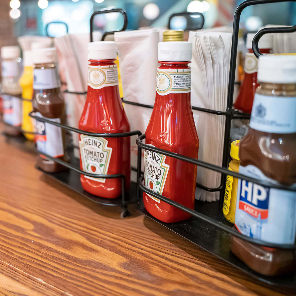 ketchup and other sauces in sauce holder at restaurant