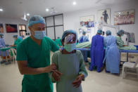 A health worker assists a patient to walk after her cataract surgery at an eye camp in Lumbini, 288 kilometers (180 miles) south west of Kathmandu, Nepal, March 31, 2021. Nepal’s “God of Sight” eye doctor renowned for his innovative and inexpensive cataract surgery for the poor is taking his work beyond the Himalayan mountains to other parts of the world so there is no more unnecessary blindness in the world. Ruit, who has won many awards for his work and performed some 130,000 cataract surgery in the past three decades, is aiming to expand his work beyond the borders of his home country and the region to go globally. (AP Photo/Bikram Rai)