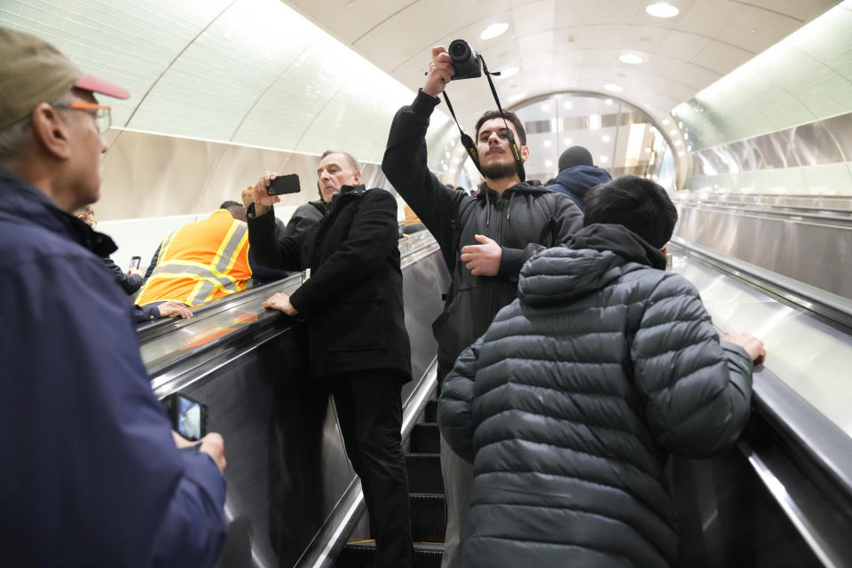 People take pictures and video in the new annex to Grand Central Station in New York, Wednesday, Jan. 25, 2023. After years of delays and massive cost overruns, one of the world's most expensive railway projects on Wednesday began shuttling its first passengers between Long Island to a new annex to New York City's iconic Grand Central Terminal. (AP Photo/Seth Wenig)