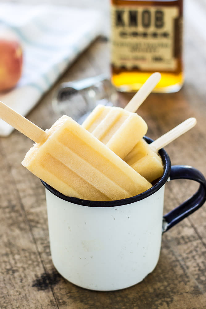 <p><b><b><b><b>Fans of American whiskey will love this frozen peachy number. A little southern comfort in an ice lolly. Recipe <a rel="nofollow noopener" href="http://thebeachhousekitchen.com/2015/06/11/bourbon-white-peach-popsicles/" target="_blank" data-ylk="slk:here" class="link ">here</a>. </b></b></b></b></p>