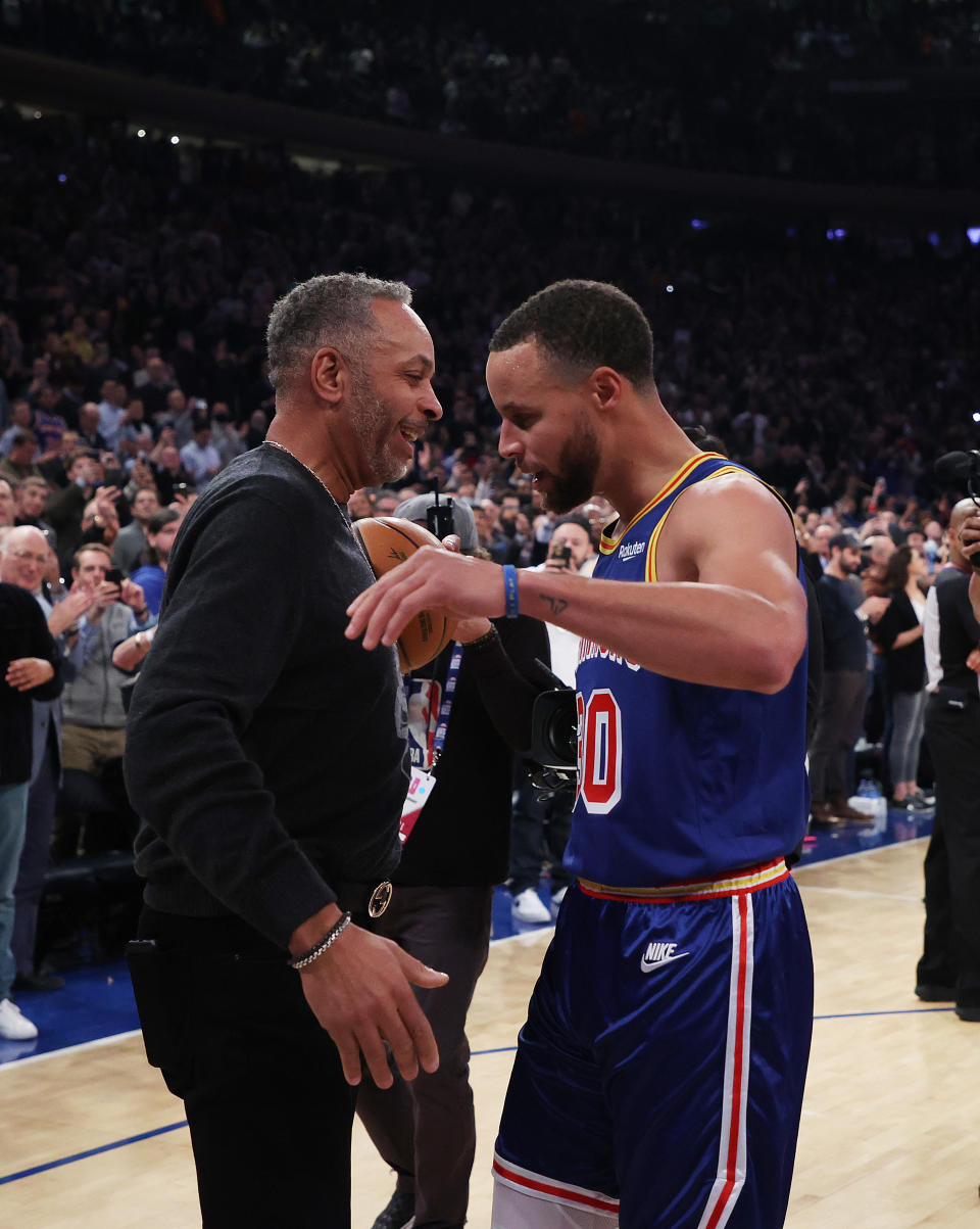 Stephen Curry (pictured right) hugs his Dad Dell Curry after making a three point basket to break Ray Allen’s record for the most all-time.