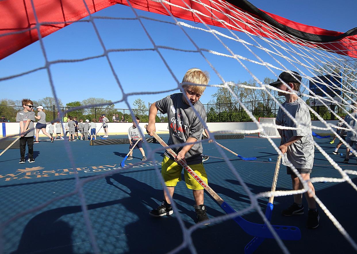 Ari Hale, 6, hits the ball into the goal during the Blue Jackets' Get Out And Learn street-hockey session at Thomas Knox Rink in Westerville May 9.