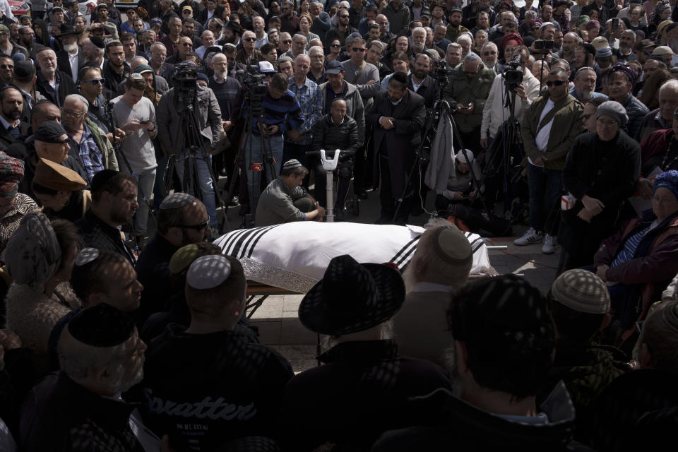 Family and friends of Yitzhak Zeiger mourn during his funeral at a cemetery in Jerusalem, Israel, Friday, March 1, 2024. Two Israelis, including Zeiger, were killed in a Palestinian shooting attack at a gas station near the Jewish settlement of Eli, in the occupied West Bank on Thursday, the Israeli military said. (AP Photo/Leo Correa)