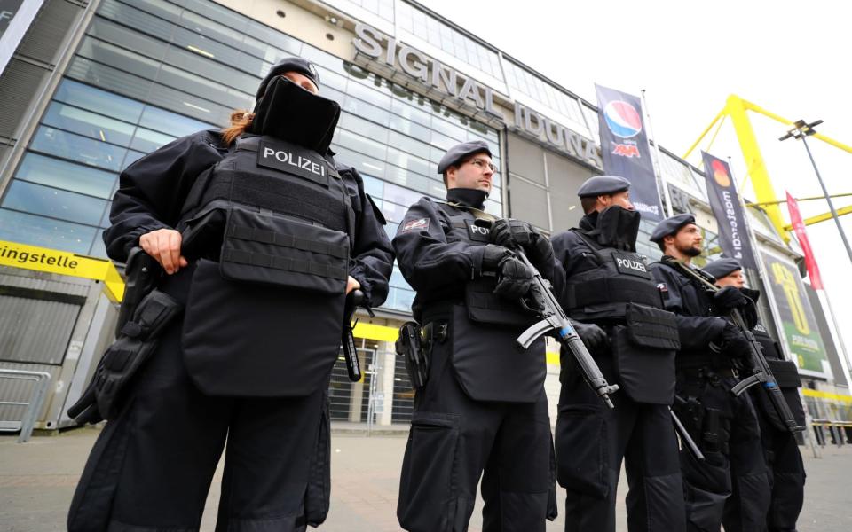 Police officers outside the stadium before the match  - Credit: Kai Pfaffenbach/Reuters