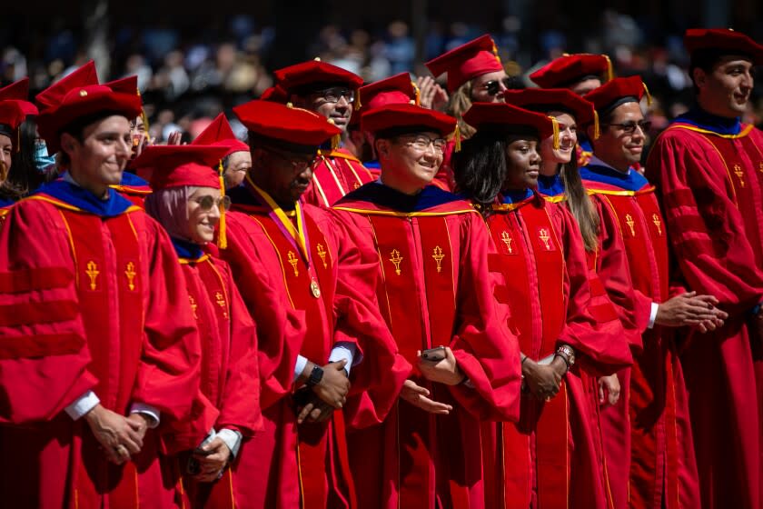 LOS ANGELES, CA - MAY 13: Graduates stand up and cheer as their school is announced at The University of Southern California's 2022 commencement ceremony on Friday, May 13, 2022 in Los Angeles, CA. (Jason Armond / Los Angeles Times)