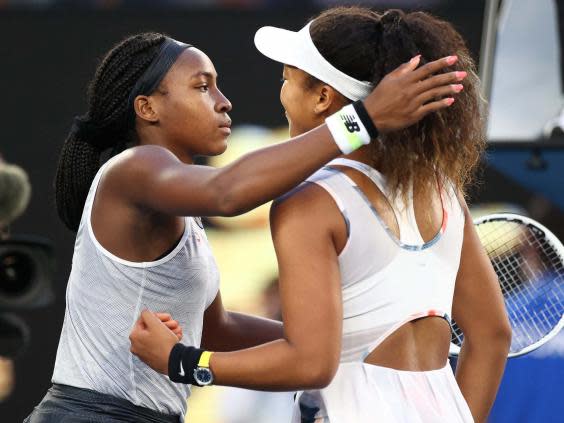 Gauff and Osaka embrace at the net after their third round match (Getty)
