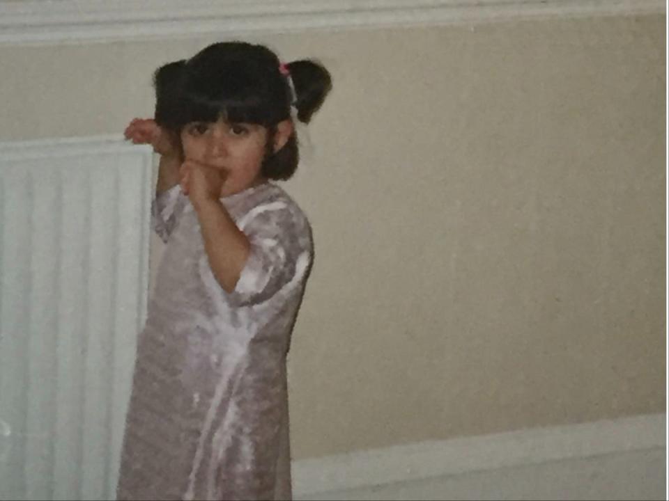 A child with a ponytail on the side of her head