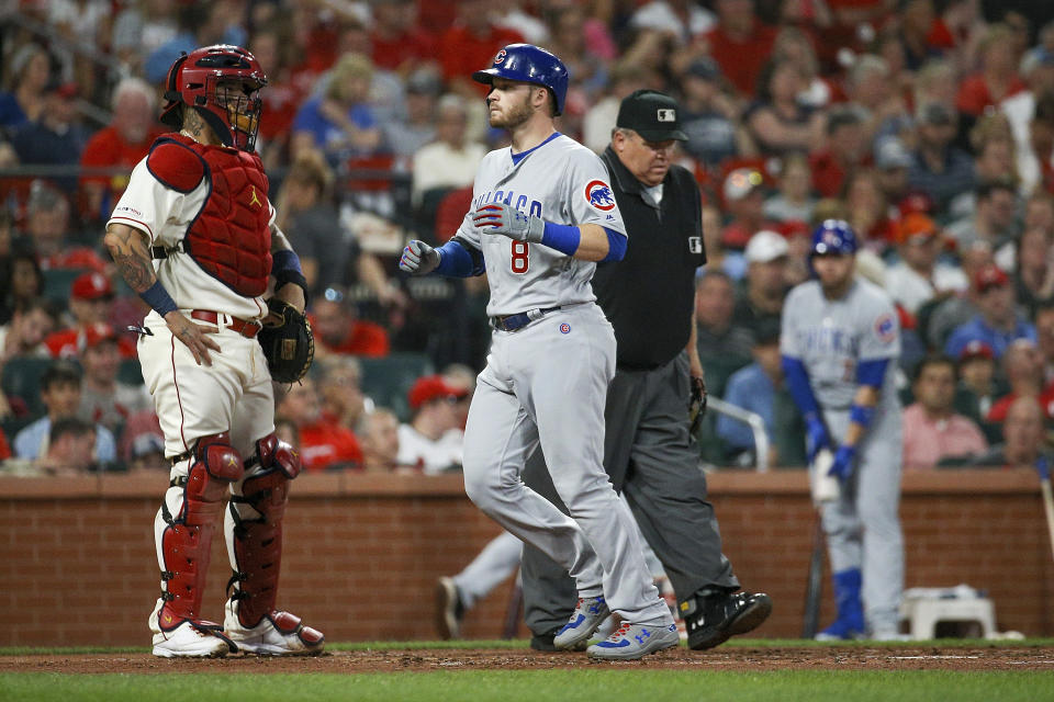 Chicago Cubs' Ian Happ, front right, scores on a two-run home run as St. Louis Cardinals catcher Yadier Molina, left, stands nearby during the third inning of a baseball game Saturday, Sept. 28, 2019, in St. Louis. (AP Photo/Scott Kane)