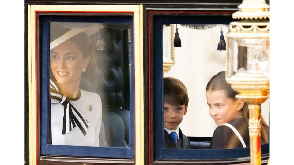 Kate Middleton riding in a carriage with Prince George and Princess Charlotte