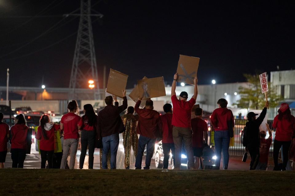 Supporters hold signs as workers leave the Ford Michigan Assembly Plant in Wayne just before UAW President Shawn Fain called for a strike after contract negotiations stalled with all three Detroit automakers, UAW members walk off the job at Ford Michigan Assembly Plant just after midnight on Fri., Sept. 15, 2023. The current four-year contracts with General Motors, Ford and Stellantis were in effect until 11:59 p.m. on Thurs., Sept. 14 and without an agreement, the UAW initiated a stand-up strike, a strategic plan that the union is said to have for a strike targeting certain plants at the different automakers in waves.