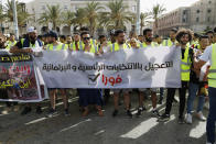 Protesters demonstrate in Martyrs Square in Tripoli, Libya, Friday, July 1, 2022, calling for election and protesting against the government and parliament. The banner reads, “Acceleration of the presidential and parliamentary elections, Immediately." (AP Photo/Yousef Murad)