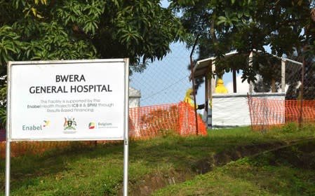 Health workers dressed in Ebola protective suits are seen as they prepare an ebola preparedness facility at the Bwera general hospital near the border with the Democratic Republic of Congo in Bwera