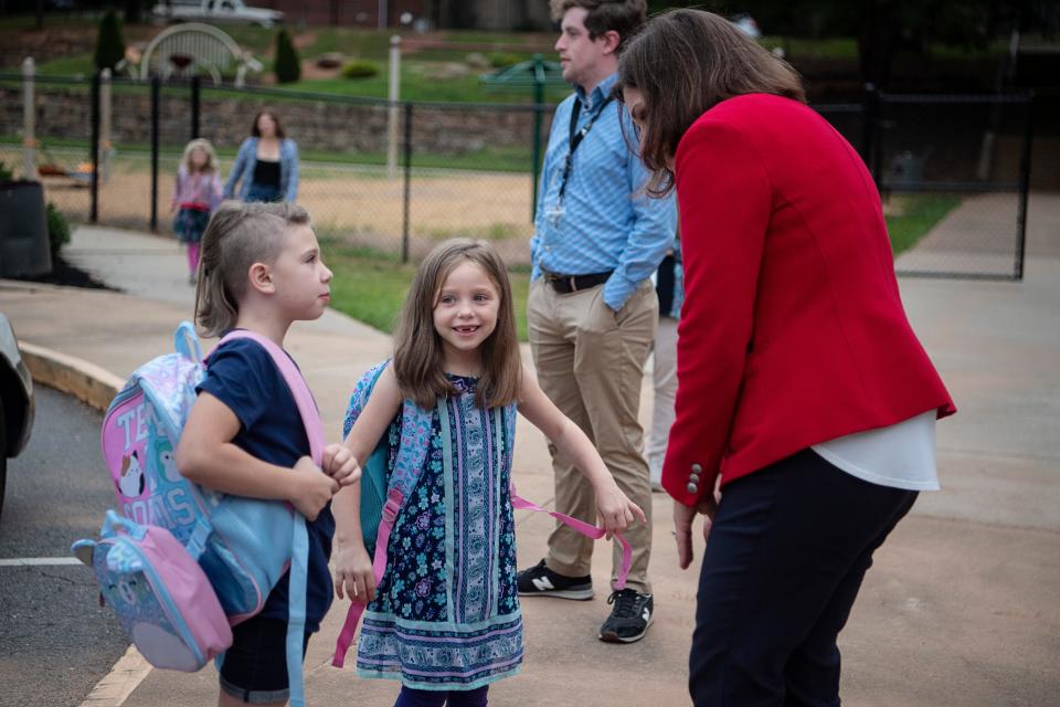 Maggie Fehrman, Asheville City School’s new superintendent, greets Hall Fletcher Elementary students on their first day of school, August 28, 2023.