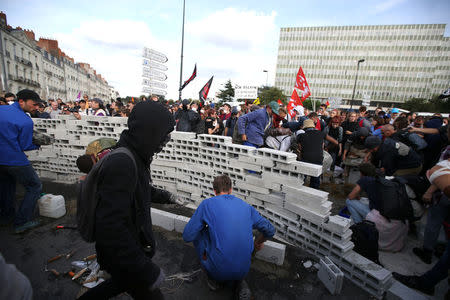 Demonstrators build a wall during a demonstration against the government's labour reforms in Nantes, France, September 21, 2017. REUTERS/Stephane Mahe