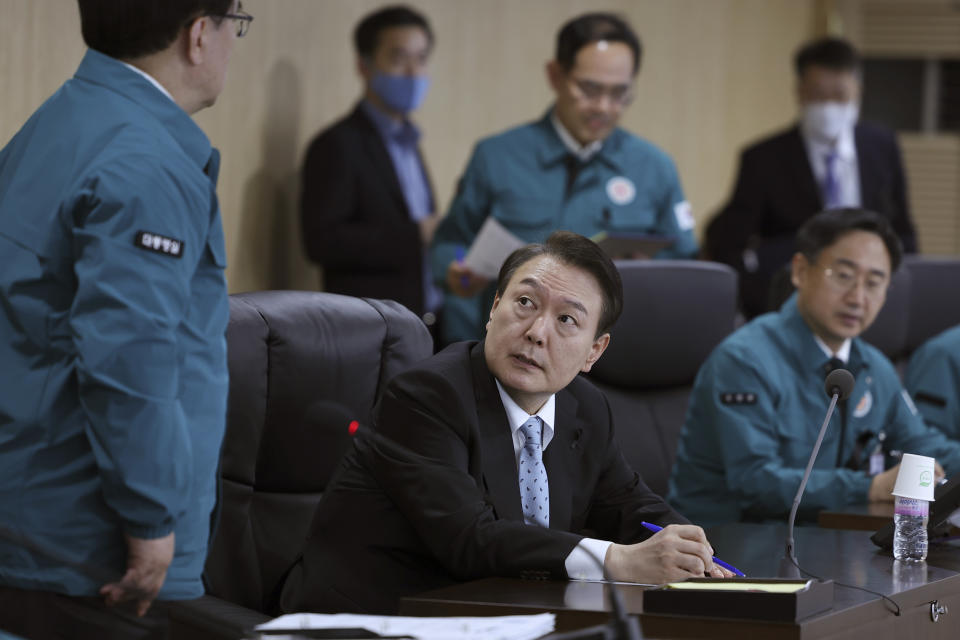 In this photo provided by South Korean Presidential Office, South Korean President Yoon Suk Yeol, center, speaks during the National Security Council (NSC) meeting at the presidential office in Seoul, South Korea, Wednesday, Nov. 2, 2022. Air raid sirens sounded in South Korea after the North fired about a dozen missiles in its direction Wednesday, at least one of them landing near the rivals' tense sea border. (South Korea Presidential Office via AP)