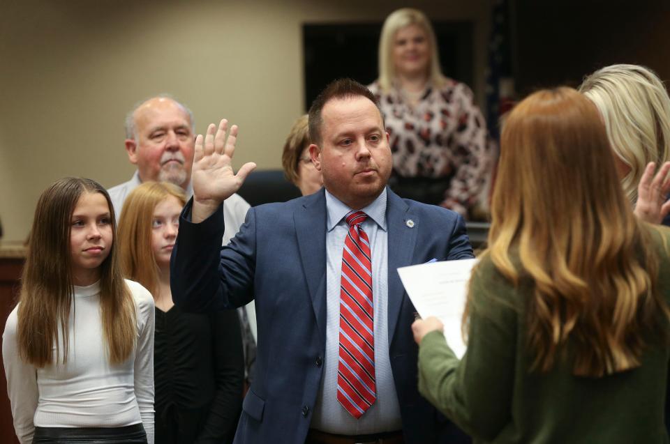 The new Northport mayor and city council were sworn in to office Monday night in the city council chambers at Northport Municipal Center. Jeff Hogg is sworn in by Heather Tomlinson. Hogg was also elected as the new City Council president. [Staff Photo/Gary Cosby Jr.]