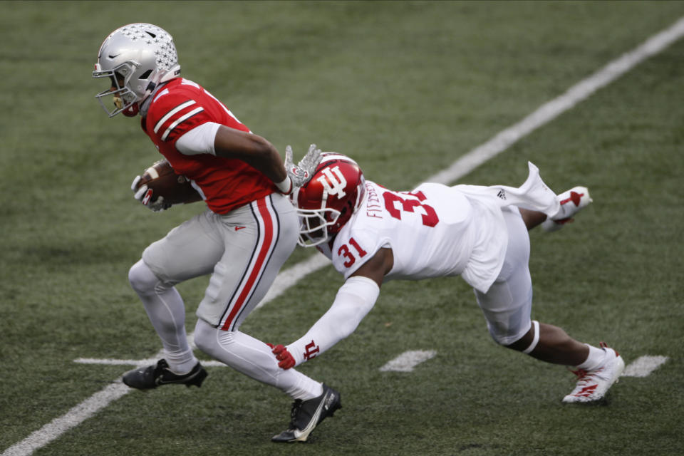 Ohio State receiver Garrett Wilson, runs after a catch past Indiana defensive back Bryant Fitzgerald during the first half of an NCAA college football game Saturday, Nov. 21, 2020, in Columbus, Ohio. (AP Photo/Jay LaPrete)