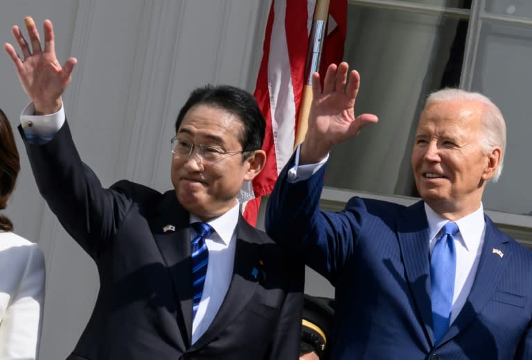 Japanese Prime Minister Fumio Kishida (L) and US President Joe Biden wave from a balcony during an Official Arrival Ceremony on the South Lawn of the White House in Washington, DC, April 10, 2024. (Mandel NGAN)