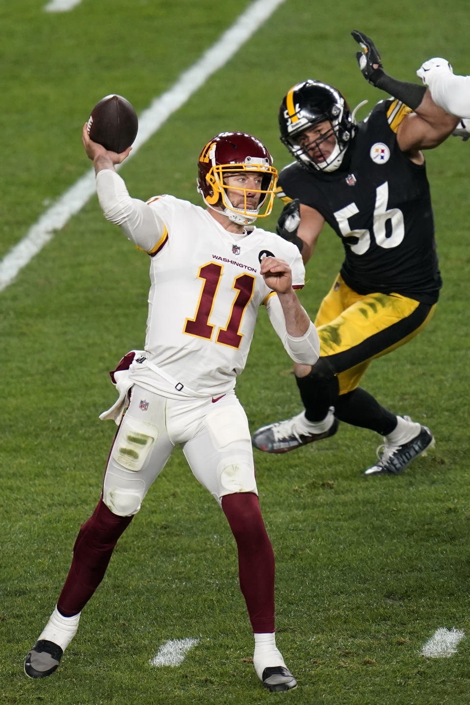 Washington Football Team quarterback Alex Smith (11) gets off a pass under pressure from Pittsburgh Steelers linebacker Alex Highsmith (56) during the first half of an NFL football game, Monday, Dec. 7, 2020, in Pittsburgh. (AP Photo/Keith Srakocic)