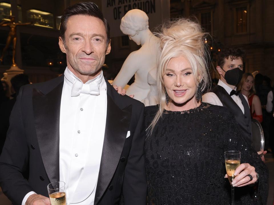 Hugh Jackman and Deborra-Lee Furness pose together with glasses of champagne at the 2022 Met Gala.