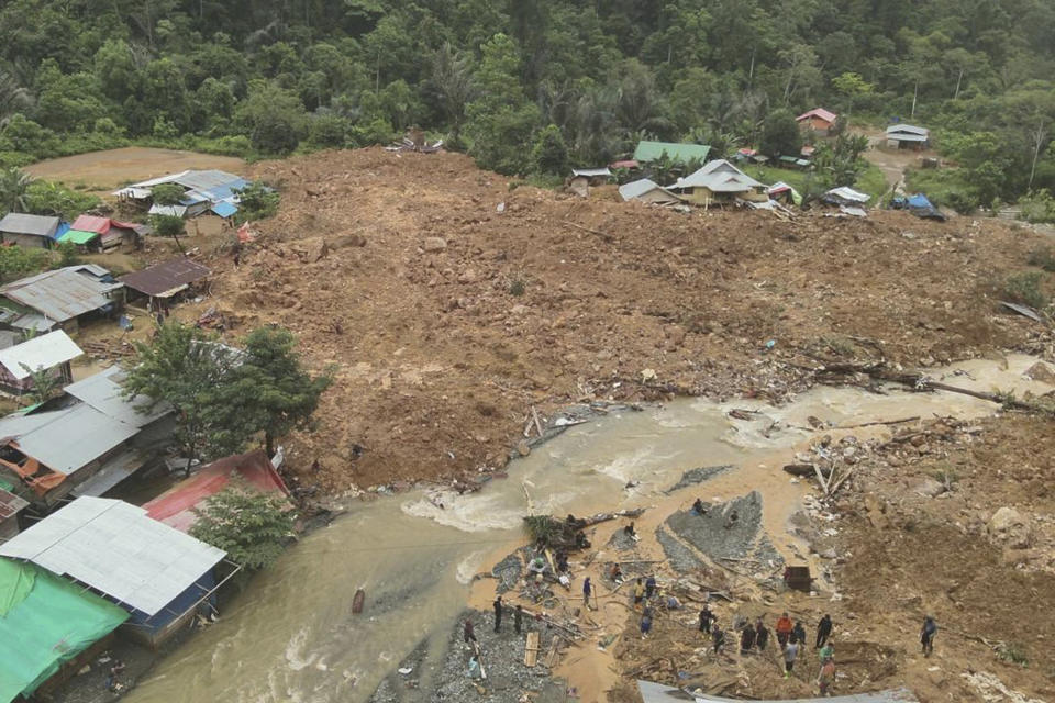 In this photo released by the Indonesian National Search and Rescue Agency (BASARNAS), rescuers search for victims at the site of a landslide in Bone Bolango in Gorontalo province, Indonesia, Wednesday, July 10, 2024. Search efforts for those trapped in a deadly landslide intensified Wednesday, with more rescuers deployed to search an unauthorized gold mine on Indonesia's Sulawesi island that saw a number of deaths over the weekend. (BASARNAS via AP)