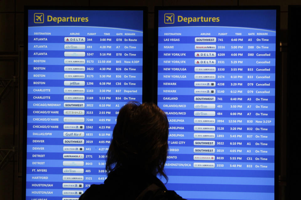 A passenger checks the departures board at Pittsburgh International Airport in Imperial, Pa, Wednesday, Oct. 31, 2012. Travel in the Northeast creaked back into motion on Wednesday, a grinding, patchy recovery that made it clear that stranded travelers will struggle to get around for days to come.(AP Photo/Gene J. Puskar)