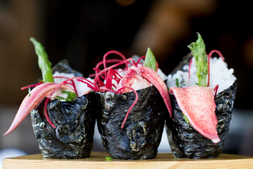 O-Ku's Lobster Temaki: Butter-poached lobster hand rolls with asparagus, chives, cilantro aioli, beets, black volcanic salt.