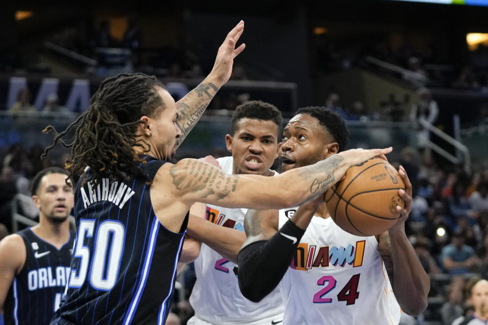Orlando Magic's Cole Anthony (50) blocks a shot attempt by Miami Heat's Haywood Highsmith (24) during the first half of an NBA basketball game, Saturday, Feb. 11, 2023, in Orlando, Fla. (AP Photo/John Raoux)