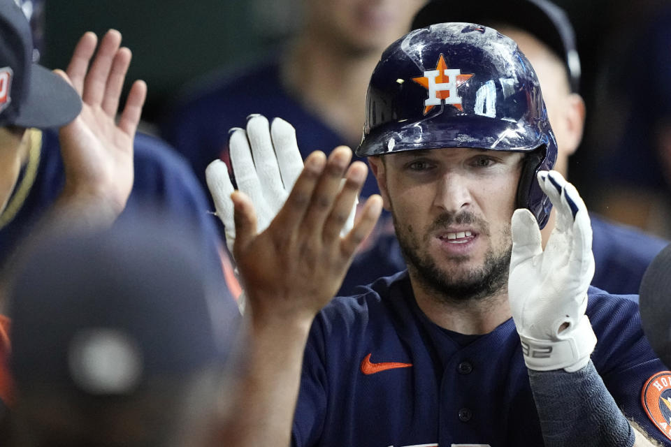 Houston Astros' Alex Bregman is congratulated in the dugout after hitting a home run against the Baltimore Orioles during the eighth inning of a baseball game Sunday, Aug. 28, 2022, in Houston. (AP Photo/David J. Phillip)