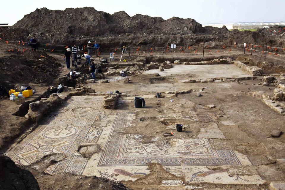 Archaeologists from Israel's Antiquities Authority work at an excavation site where a mosaic floor of an ancient Byzantine church was uncovered near Kiryat Gat