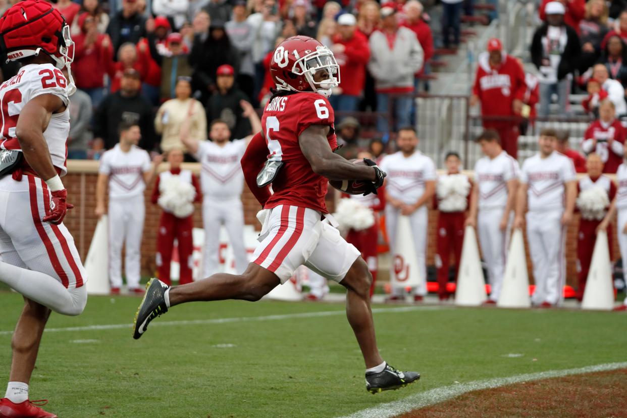 OU's Deion Burks runs to the end zone for a touchdown after a reception during the Sooners' spring game Saturday at Gaylord Family-Oklahoma Memorial Stadium in Norman.