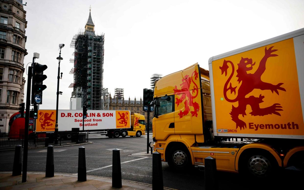 Lorries from Scotland drive past the Houses of Parliament in a protest action by fishermen against post-Brexit red tape and coronavirus restrictions - AFP