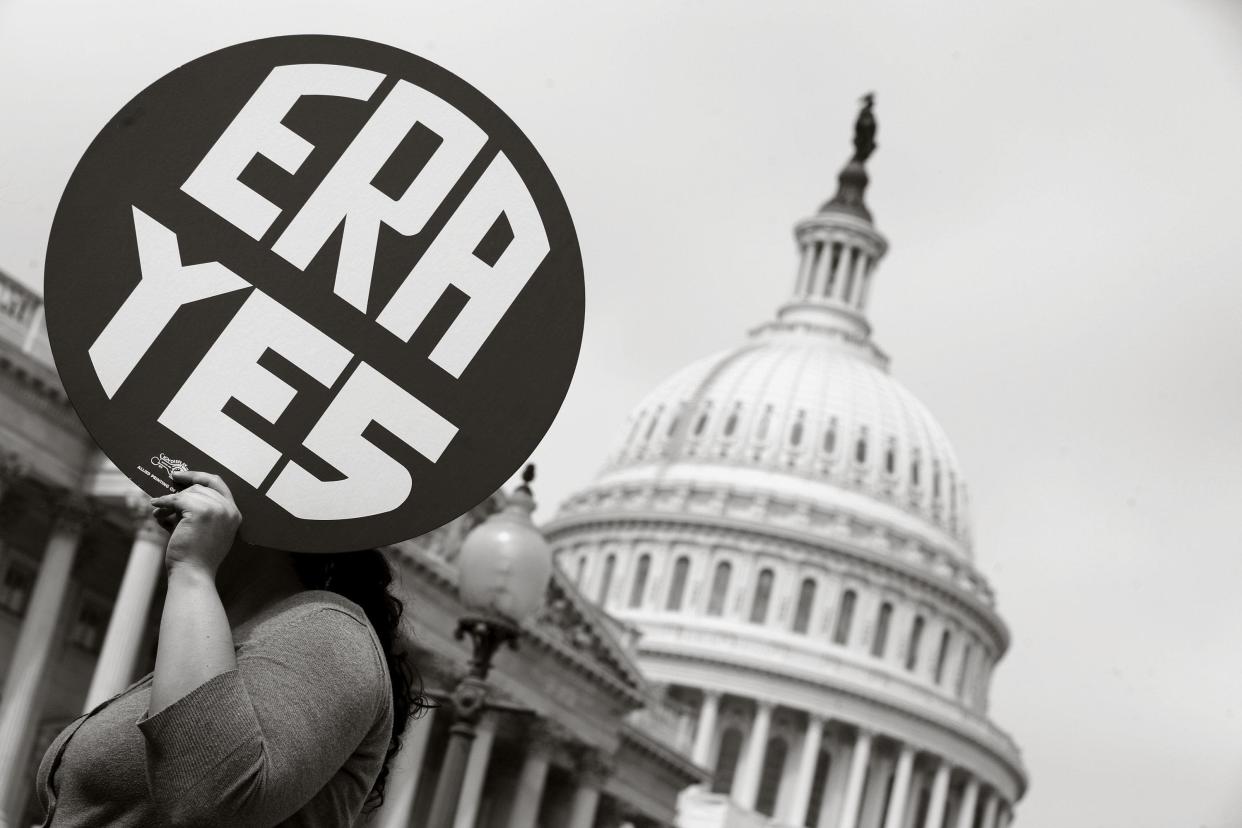 A woman holds up a sign as members of Congress and representatives of women's groups rally in 2012 to mark the 40th anniversary of congressional passage of the Equal Rights Amendment. The amendment included what the Congressional Research Service calls a "customary, but not constitutionally mandatory," seven-year deadline for ratification by three-fourths of the states.