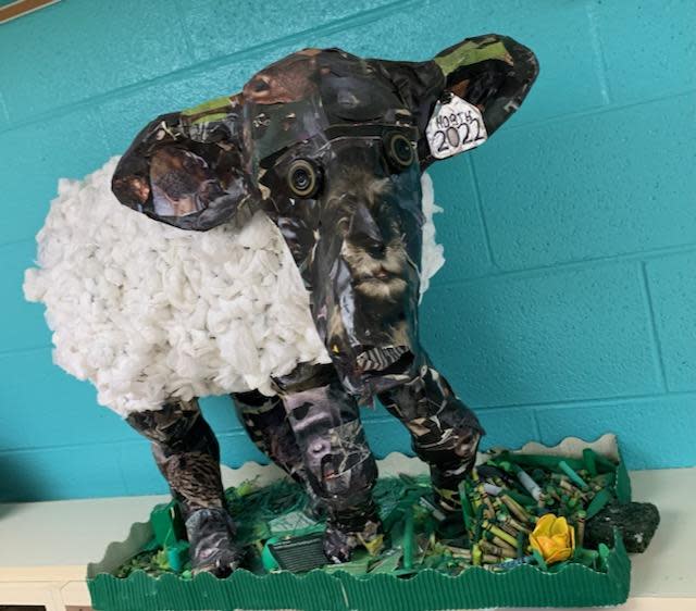 A piece of Debbie Conner's art made from recycled items is shown.