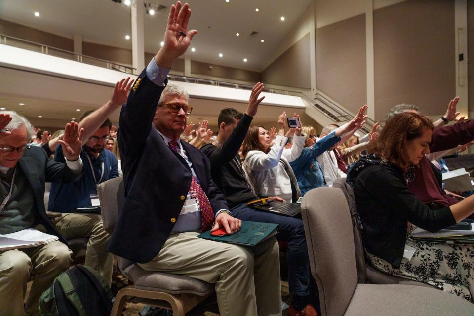 Delegates put their hands in the sky as to reach out as Rev. Dr. Carolyn Moore announces Friday, May 6, 2022, Jay Therrell, president of the WCA-Florida, as the new president of Wesleyan Covenant Association.