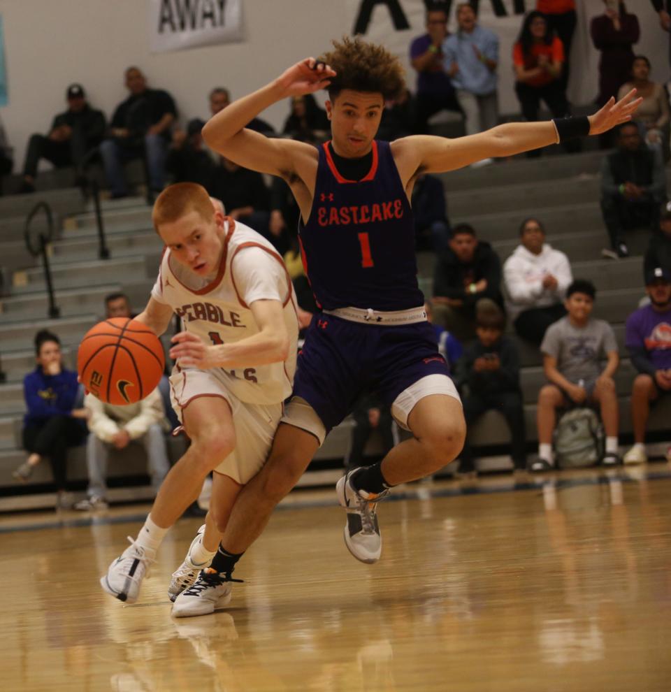 Pebble Hills' Mark Barajas runs a play as Eastlake's Derek Mendez puts pressure in the last seconds of their game at Pebble Hills High School on Jan. 2, 2023. Eastlake won the match 44-41.