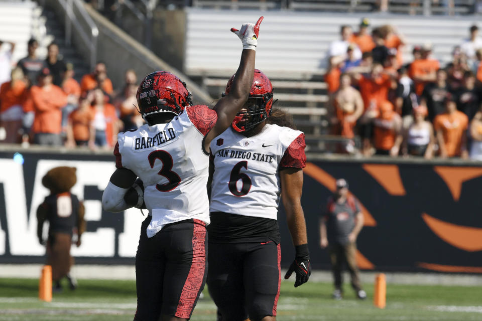 San Diego State safety Cedarious Barfield (3) celebrates his interception with linebacker Zyrus Fiaseu (6) during the second half of an NCAA college football game against Oregon State Saturday, Sept. 16, 2023, in Corvallis, Ore. (AP Photo/Mark Ylen)