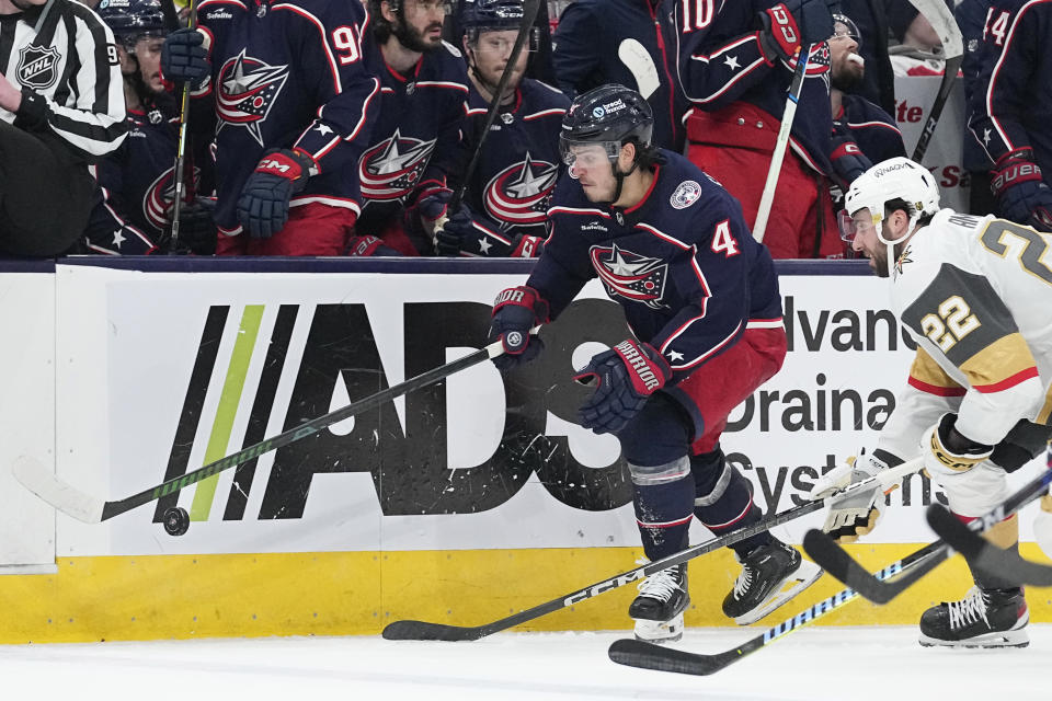 Columbus Blue Jackets center Cole Sillinger (4) carries the puck in front of Vegas Golden Knights right wing Michael Amadio (22) in the second period of an NHL hockey game Monday, March 4, 2024, in Columbus, Ohio. (AP Photo/Sue Ogrocki)