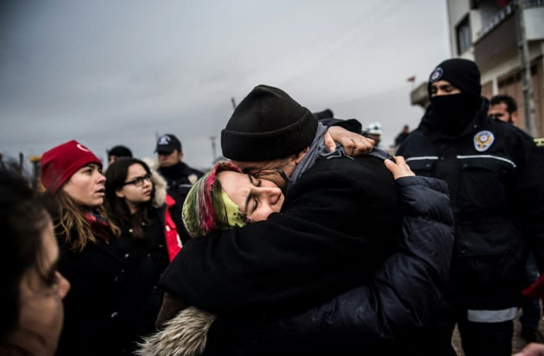 Fevziye Demir hugs her father after a rocket fired from across the border in Syria hit her house in Kilis in Turkey